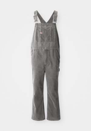 Grijze denim salopettes met verstelbare bandjes, een borstzak aan de voorkant, zakken aan de zijkanten en flared pijpen. Stevige stof en een ontspannen pasvorm voor comfort.
