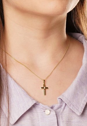 Gold cross pendant necklace on a fine chain, with a polished finish. Worn over a light purple collared shirt.