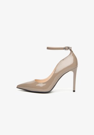 Shiny taupe high-heeled pump with pointed toe, slim heel, and ankle strap featuring a small rhinestone buckle.