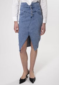 Jupe en denim crayon taille haute, avec une fente à l'avant, fermeture à cinq boutons et deux poches latérales. Couleur bleu clair et coutures structurées.