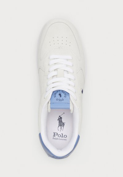 White sneakers with a smooth suede finish, flat white laces, light blue tongue, and logo detail. Perforated toe design for breathability.