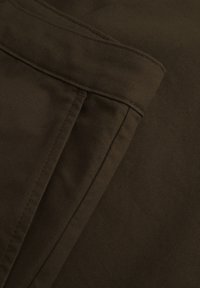 Brown cotton fabric with a smooth texture. Features folded seams, a subtle diagonal weave, and a clean edge finish.