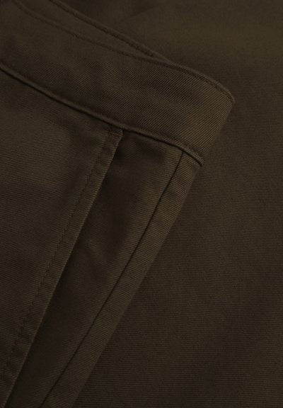 Brown cotton fabric with a smooth texture. Features folded seams, a subtle diagonal weave, and a clean edge finish.