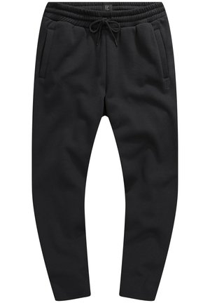 Pantaloni sportivi neri realizzati in tessuto testurizzato, con cintura elastica e cordoncino, tasche laterali e una vestibilità a gamba affusolata.