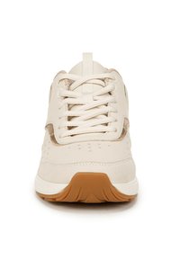 Beige athletic shoe featuring a smooth upper with perforations, laces, and a textured rubber sole with a light brown accent.