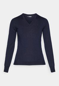 Marinblå v-ringad tröja gjord av lätt stickad tyg. Har långa ärmar och en åtsittande design med ribbade muddar och nederkant.