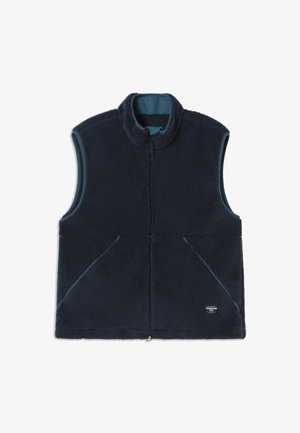 Gilet in pile blu navy con collo alto, design senza maniche e due tasche frontali. Presenta una fodera interna a contrasto e un logo del marchio discreto.