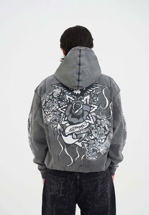 Grau-denim Kapuzenpullover mit detailliertem schwarz-weißem Blumen- und Tiger-Graphic auf dem Rücken, in lockerer Passform und mit Kordelzug-Kapuze.