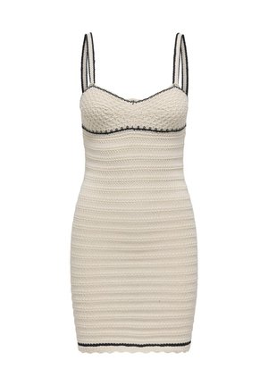 Valge kudumkleit, millel on liibuv vorm, õhukesed rihmad, laineline äär ja kontrastne must ääris kaeluse ja äärte juures.