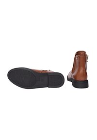 Stivali ankle in pelle marrone con una finitura liscia, punta arrotondata, dettagli con cerniera e una suola in gomma nera testurizzata. La vista laterale mostra la forma e l'altezza.