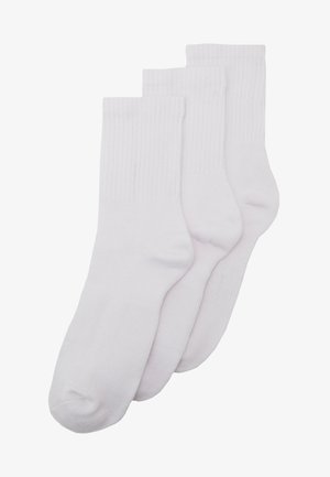 White cotton crew socks, featuring ribbed texture and reinforced heels. Pack includes three pairs, each with a seamless toe design.