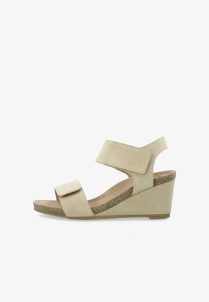 Beige nahkasaapad, millel on sametine viimistlus, laia pahkluu rihmaga, reguleeritava Velcro sulgemisega ja tekstuuriga korkplatvormiga.