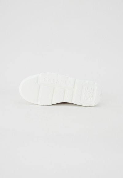 White rubber sole with textured grip, featuring embossed logo details. Smooth edges with ridged pattern for traction. Durable design.