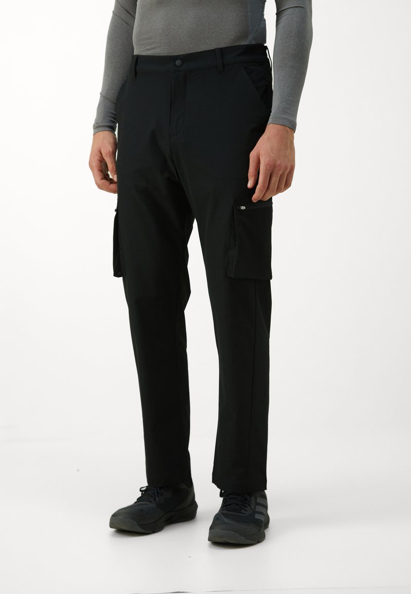 Black cargo pants with side pockets, made from lightweight material. Features a button closure and fitted design for a streamlined look.