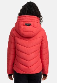 Red puffer jacket features a chevron quilted design, a hood with a branded label, and elastic cuffs. The material appears smooth and insulated.