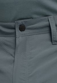 Gray fabric shorts with a smooth texture, featuring a black button and contrasting stitching along the seams and pockets.