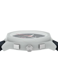 Chronograph watch with a gray case, black dial, red accents, and silver buttons. Features a rubber strap and raised glass.