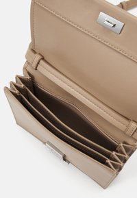 Calvin Klein LINEAR CROSSBODY - Cross body bag - chanterelle