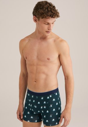 Männer Boxer Shorts aus dunkelblauem Stoff mit einem Frosch-Muster, ausgestattet mit einem marineblauen Bund. Weiche Textur und körpernahe Passform für optimalen Komfort.