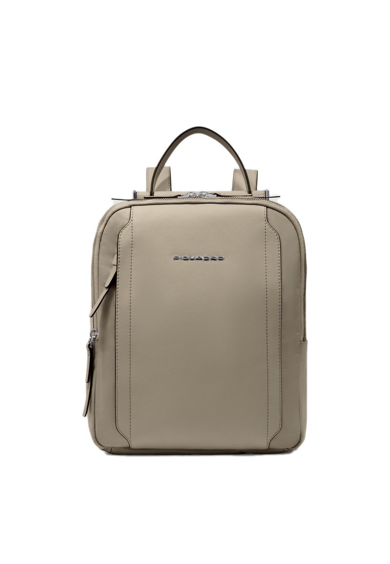 Mochila de cuero beige con dos asas superiores, cierre de cremallera y un logotipo frontal. Presenta un diseño rectangular elegante y detalles visibles de costuras.