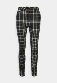 Leggings xadrez em preto e branco com um corte slim. Feitas de um tecido macio, apresentam uma cintura elástica e dois bolsos laterais.