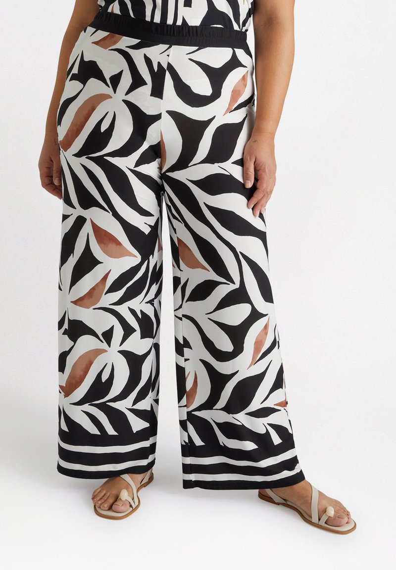 Wide-leg trousers in a black and white leaf print with brown accents. Made of lightweight fabric, featuring an elastic waistband and striped hem.
