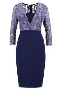Robe bleu marine longueur genou avec manches longues en dentelle violette et superposition de dentelle florale sur le corsage supérieur, avec un profond décolleté en V.