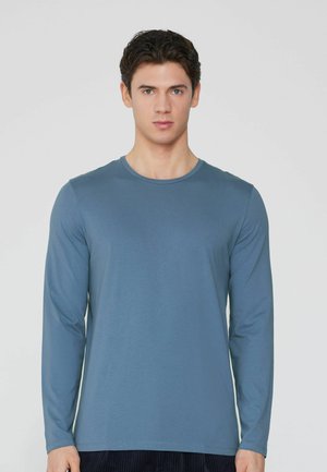 Langärmliges T-Shirt aus weichem, leichtem Stoff in einem gedeckten Blau. Verfügt über einen Rundhalsausschnitt und eine taillierte Passform.