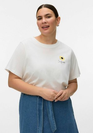 Woman wearing white T-shirt with small sunflower graphic and "Sunflower" text, paired with high-waisted blue denim skirt with belt.