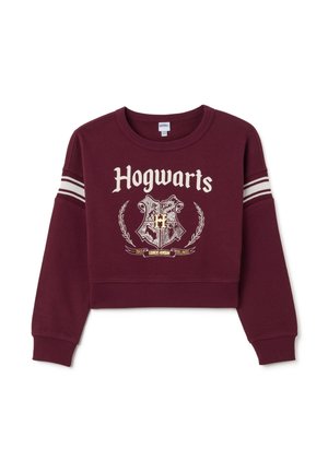 Sweatshirt court bourgogne avec des rayures blanches sur les manches, arborant le texte "Hogwarts" et un design de blason en or et noir. Matière en coton.
