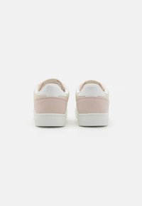 Pink suede and white leather sneakers, featuring a rounded toe, cushioned collar, and rubber sole, viewed from the back.