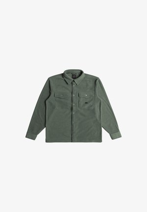 Green flannel shirt with a button-down collar, long sleeves, two chest pockets, and a soft texture. Features a front button closure.