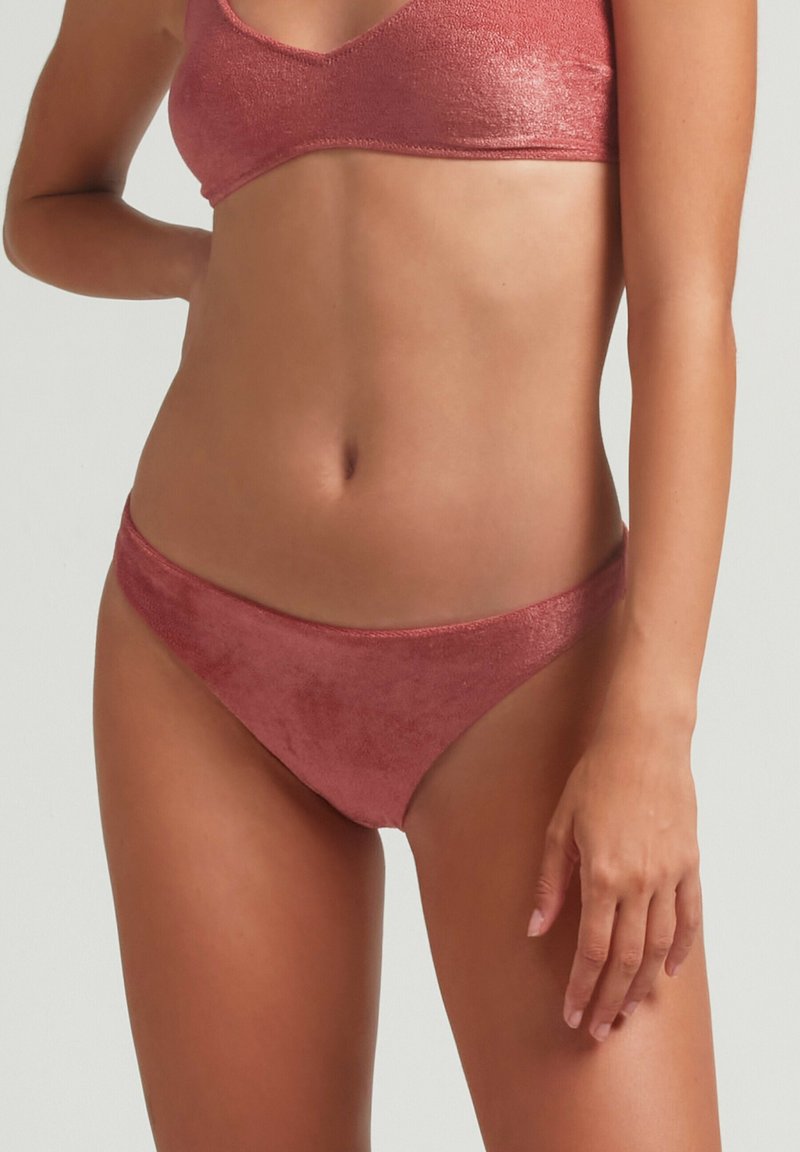 Conjunto de bikini rosa y brillante hecho de una tela texturizada; incluye un top estilo bralette y una parte inferior de corte bajo con bordes suaves.