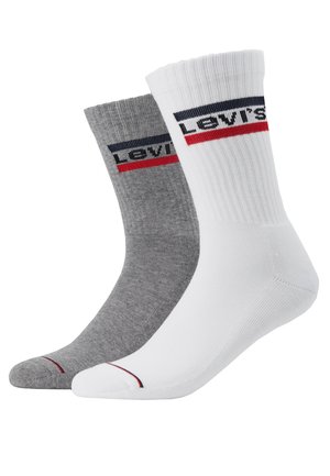 Cirkelsockor i bomullsblandning, en grå och en vit, med kontrasterande Levi's-märke och röda och marinblå ränder upptill.