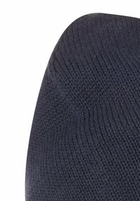 Knitted dark navy beanie featuring a soft texture and a rounded shape, with visible ribbed pattern throughout.