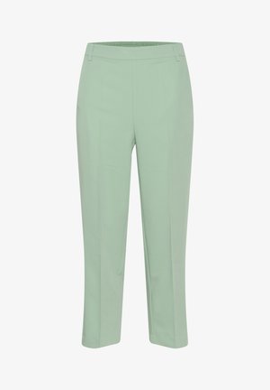 Pantaloni cropped verde chiaro con una texture liscia, dotati di una vita elastica, gambe dritte e senza hardware o motivi visibili.