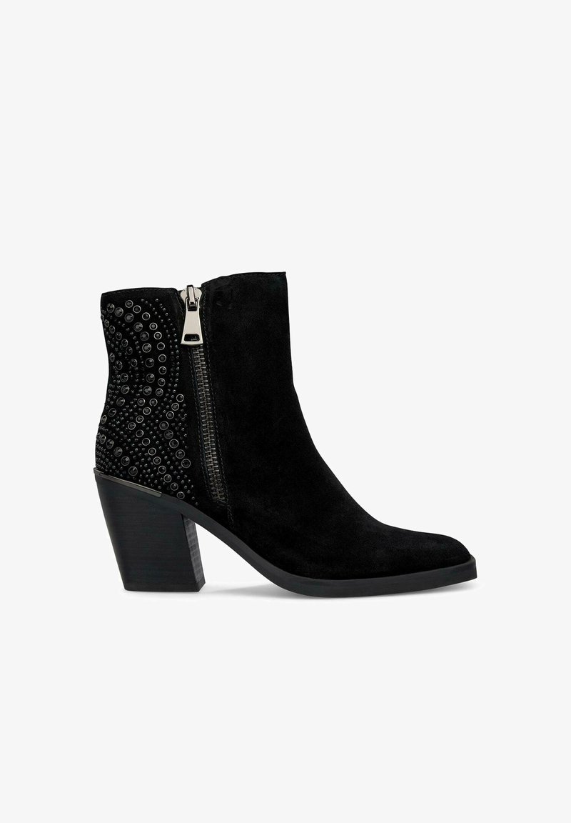 Czarne zamszowe botki za kostkę na wysokim słupku, z dekoracyjnym wzorem z metalowymi ćwiekami po jednej stronie oraz zapięciem na zamek.