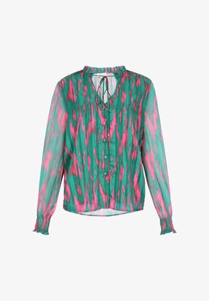 Poolik pikkade varrukatega pluus, millel on roheline ja roosa abstraktne muster, nööpidega ees ja seotud detail kaeluses. Rinnapüksid.