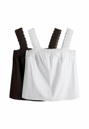 Zwei ärmellose Tops mit Spitzenträgern, eines weiß mit weißen Trägern und eines schwarz mit schwarzen Trägern, überlappend auf weißem Hintergrund dargestellt.