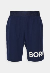 Marinblå shorts med elastisk midjeband och svart logotryck, samt en vit texturerad "BORG"-detalj på vänster ben.