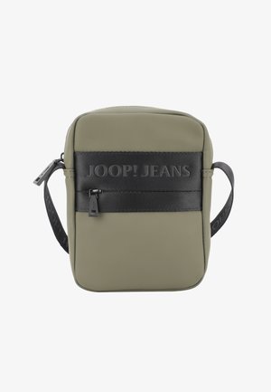 Olive green crossbody bag with a smooth texture, black branding strap, a zipper closure, and a compact rectangular design.