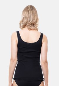 Black, fitted tank top with a scoop neckline and wide straps, made of soft, stretchy fabric; smooth texture and no visible patterns.