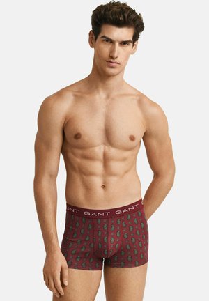 Bordeauxrote Boxershorts mit Paisley-Muster, mit einem elastischen Bund mit dem "GANT"-Logo, aus einem weichen Stoff gefertigt.