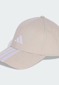 Beige baseball cap made of fabric with white stripes on the brim and a white logo accent. Features ventilation holes and a curved visor.