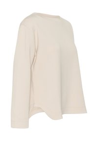 Chemise beige à manches longues et col ras du cou, coupe décontractée avec ourlet incurvé, présentée sur un fond blanc.