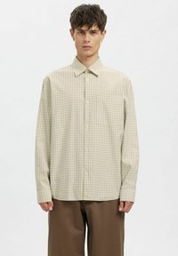 Helebeež toonides ruuduline särk nööpidega kaelusega, pika varrukaga ja �ühe rinnataskuga. Pehme, kootud kangast tekstuur.