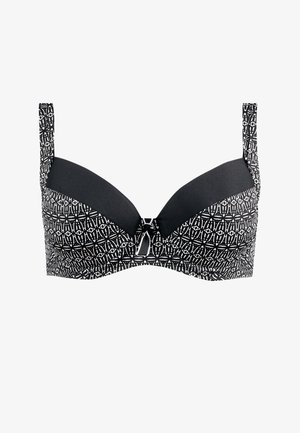 Czarny i biały stanik z fiszbinami w wzory, z uformowanymi miseczkami, regulowanymi ramiączkami oraz małą ozdobną kokardką na środku przodu.