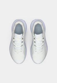 Λευκά αθλητικά παπούτσια με υφασμάτινη επένδυση με υφή, ανοιχτό γκρι λεπτομέρειες, στρογγυλή μύτη και επίπεδα κορδόνια. Μαλακή σόλα με ορατά χαρακτηριστικά απορρόφησης κραδασμών.