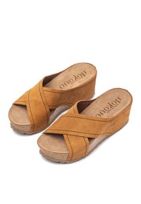 Brown suede wedge sandals with crisscross straps, natural cork footbed, and textured rubber sole. Features stitched detailing and open toe.