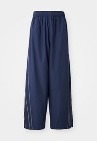 Navy blue, loose-fitting pants with an elastic waistband and side stripes in a lighter shade. Made of smooth, lightweight material.
